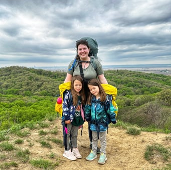 Amy and her 6 year old daughters pose for a photo